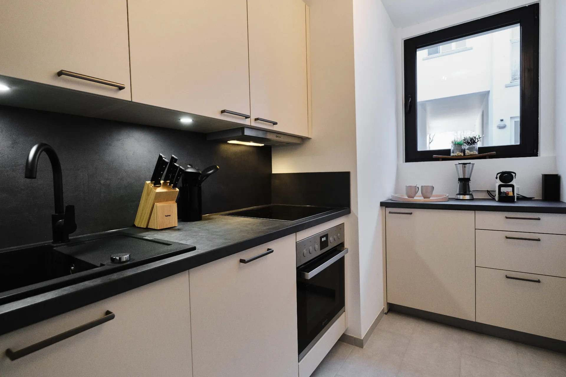 Voll ausgestattete Küche mit Backofen und Kaffeemaschine
